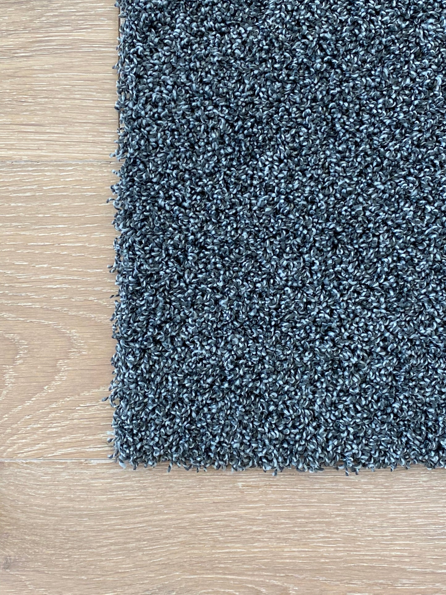 Dark gray machine washable carpet tile.